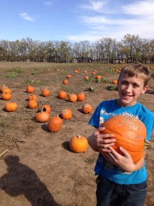 Boo is holding his 13 lb. pumpkin